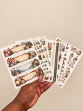 Winter Wonderland Deluxe eight-sheet planner sticker set with snowy chalets, evergreen branches, and cozy winter decorations.