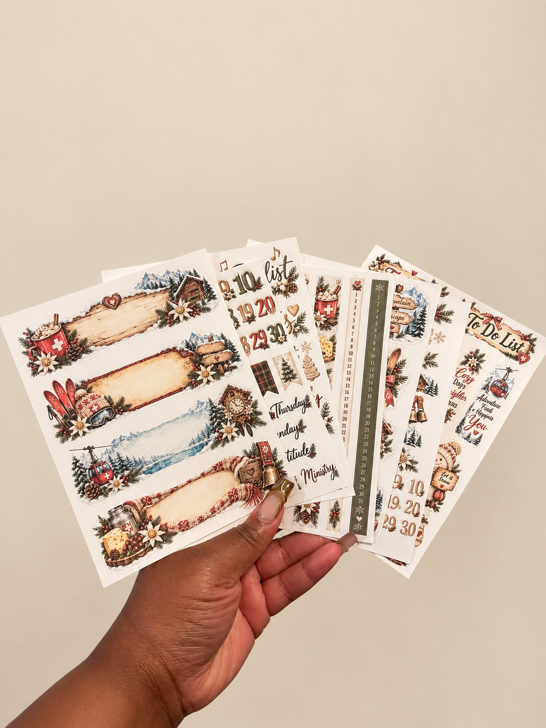 Winter Wonderland Deluxe eight-sheet planner sticker set with snowy chalets, evergreen branches, and cozy winter decorations.